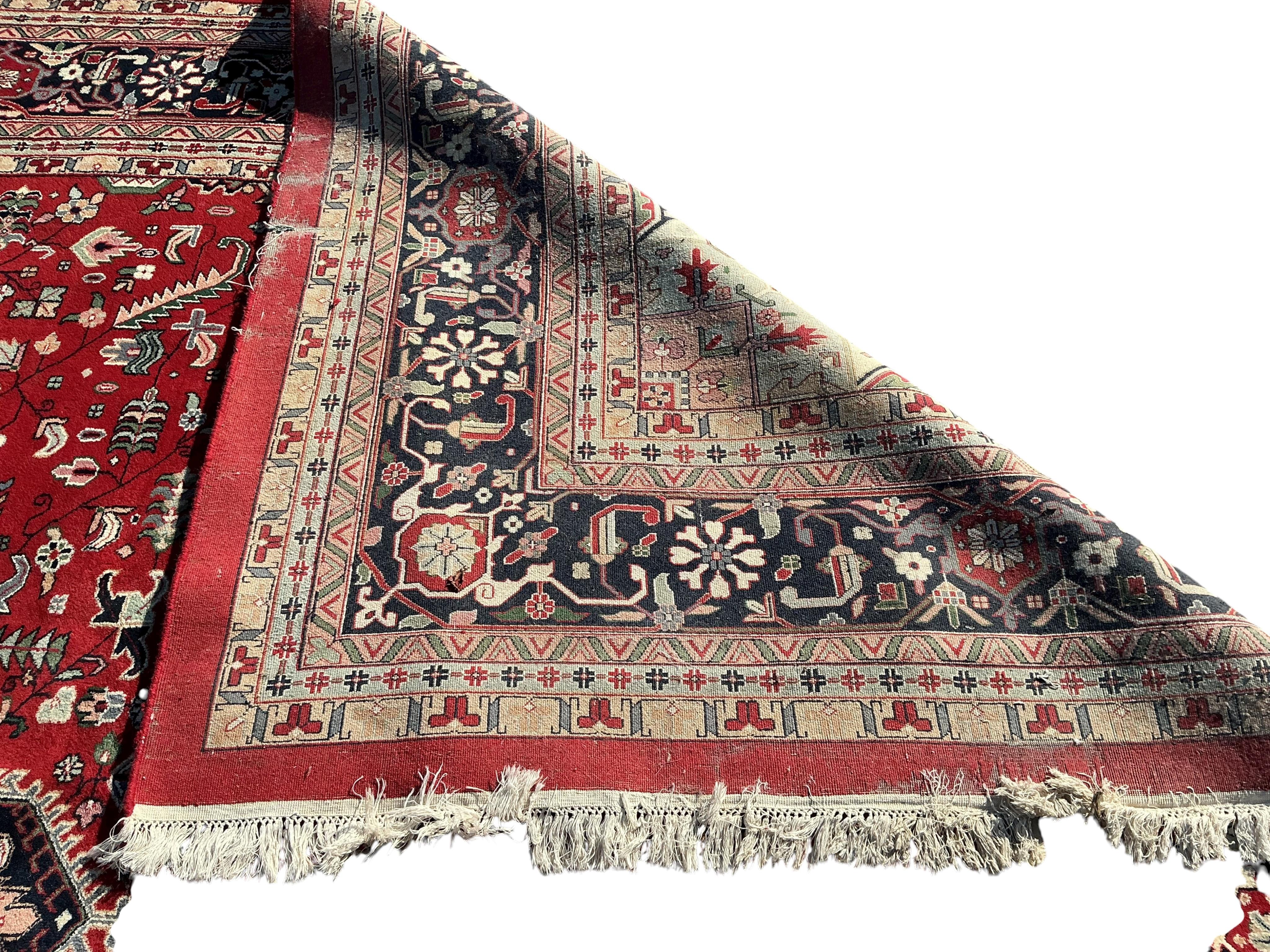 A Heriz red ground carpet, (some old moth damage, now inactive) 455 x 362cm